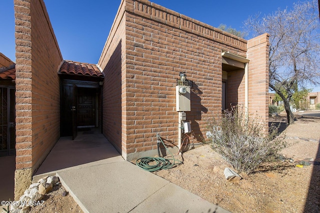 property entrance featuring a tiled roof