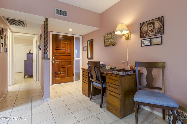 office space with light tile patterned floors, baseboards, and visible vents