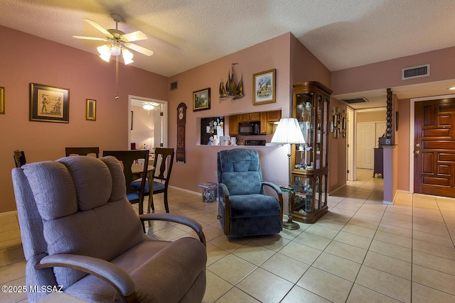 living room with visible vents, ceiling fan, a textured ceiling, and light tile patterned flooring