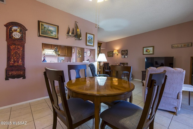 dining area featuring visible vents, a textured ceiling, baseboards, and light tile patterned floors