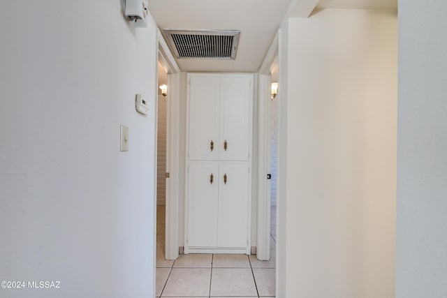 hallway with light tile patterned floors and visible vents