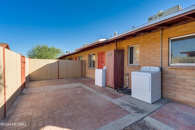 view of patio with a fenced backyard and washer / dryer