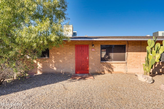 property entrance with brick siding