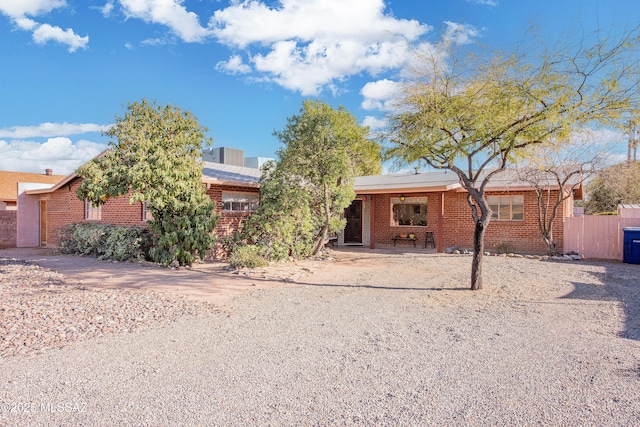 single story home with brick siding and fence