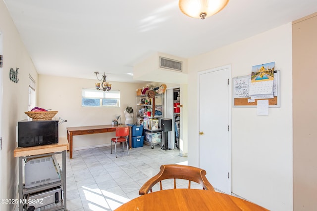 dining area featuring visible vents and an inviting chandelier