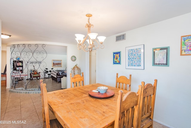 dining room featuring light tile patterned floors, a chandelier, and visible vents