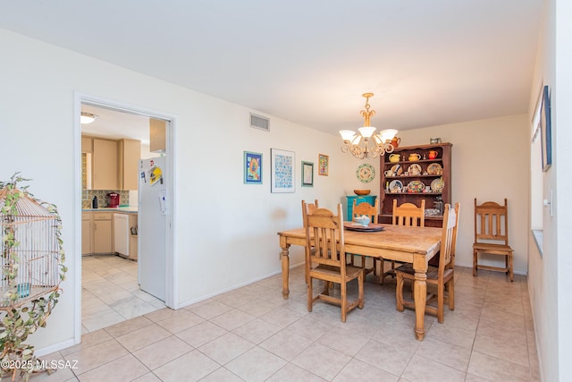 dining area with baseboards, visible vents, a notable chandelier, and light tile patterned flooring