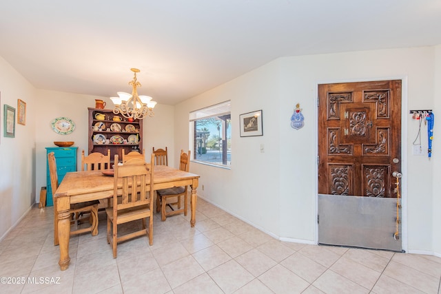 dining area with a chandelier, baseboards, and light tile patterned floors