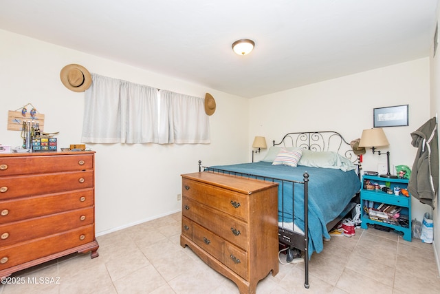 bedroom with light tile patterned floors