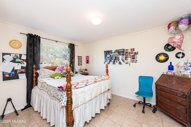 bedroom with light tile patterned floors and baseboards