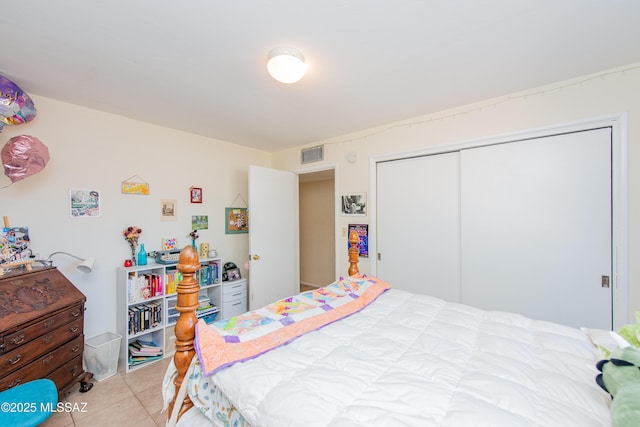 bedroom with visible vents, a closet, and light tile patterned flooring