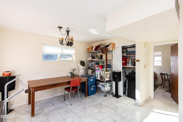 home office featuring baseboards and an inviting chandelier