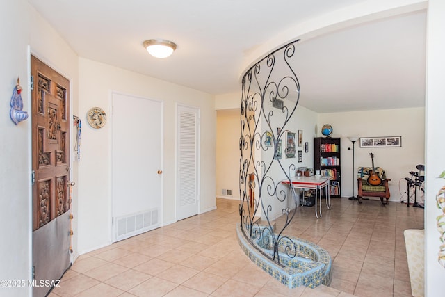 tiled foyer featuring visible vents