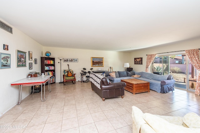 living area with light tile patterned flooring and visible vents