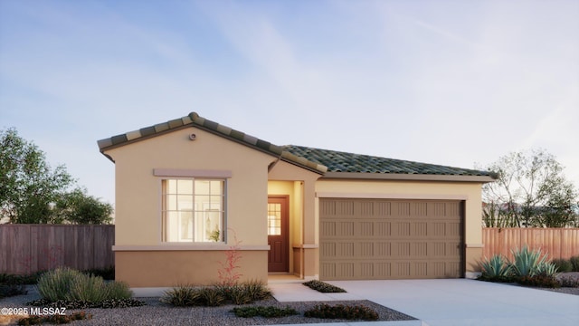 mediterranean / spanish-style house featuring fence, an attached garage, and stucco siding