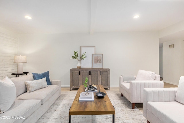 living room featuring light wood-style floors, baseboards, and recessed lighting