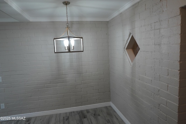 interior space with crown molding, baseboards, and wood finished floors