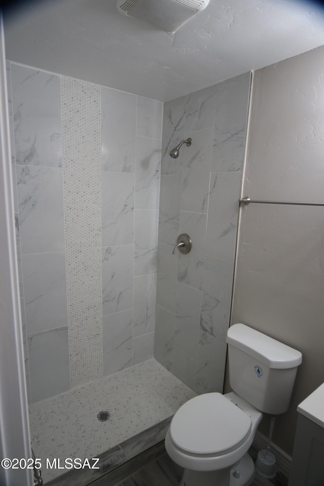 bathroom featuring visible vents, vanity, toilet, and a shower stall