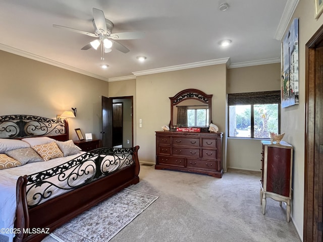 carpeted bedroom with a ceiling fan, baseboards, and ornamental molding