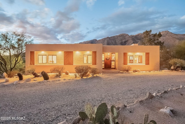 pueblo revival-style home with stucco siding and a mountain view