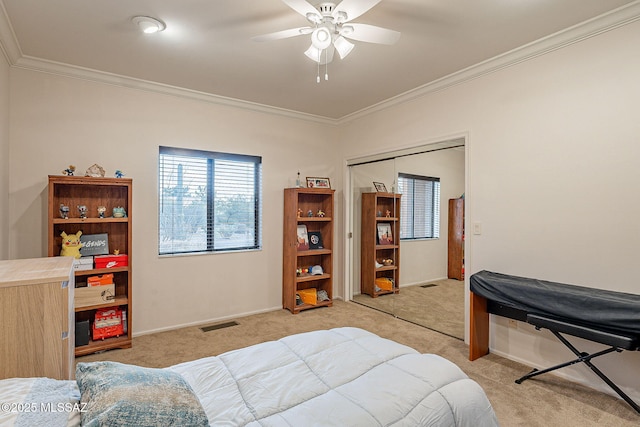 bedroom featuring baseboards, ceiling fan, ornamental molding, a closet, and light colored carpet