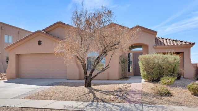 view of front of property with an attached garage, concrete driveway, and stucco siding