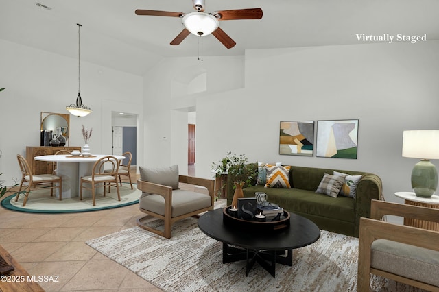 living room with high vaulted ceiling, light tile patterned flooring, ceiling fan, and visible vents