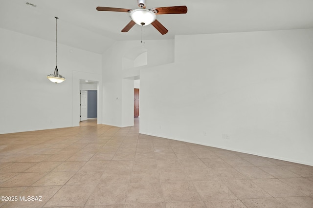 empty room featuring ceiling fan, visible vents, high vaulted ceiling, and baseboards