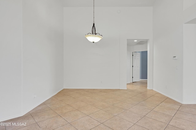 unfurnished dining area featuring baseboards and light tile patterned floors