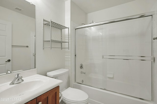 full bathroom with visible vents, shower / bath combination with glass door, vanity, and toilet