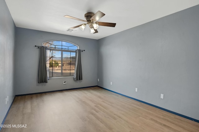 unfurnished room with ceiling fan, baseboards, visible vents, and light wood-style floors