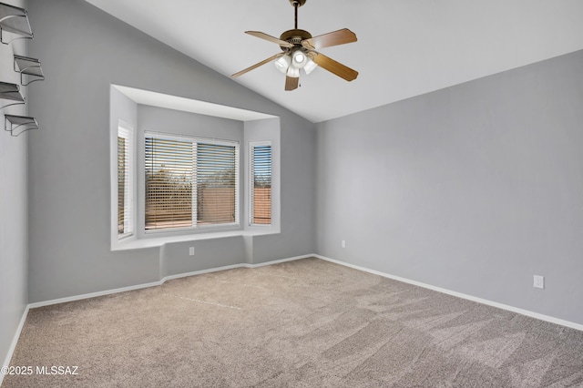 unfurnished room with a ceiling fan, lofted ceiling, light carpet, and baseboards