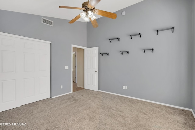 unfurnished bedroom with carpet, a closet, visible vents, and baseboards