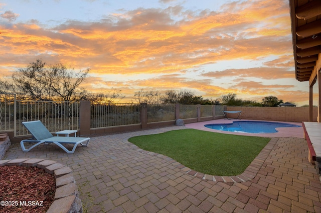 view of swimming pool with a fenced in pool, a yard, a fenced backyard, and a patio