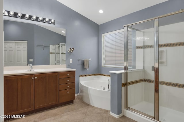 full bath with a stall shower, tile patterned floors, a garden tub, and vanity