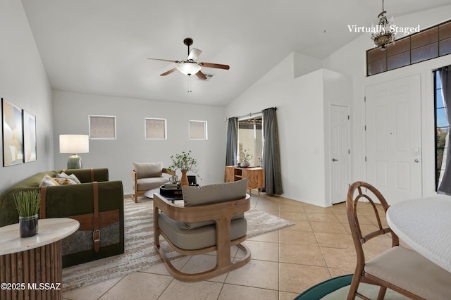 living room with light tile patterned floors, vaulted ceiling, and a ceiling fan