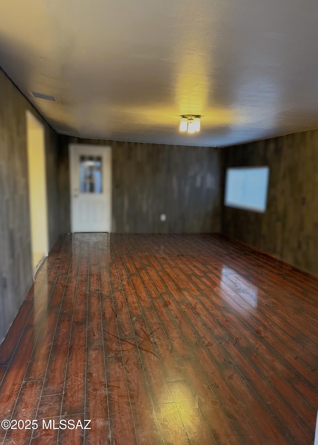 spare room with dark wood finished floors and visible vents