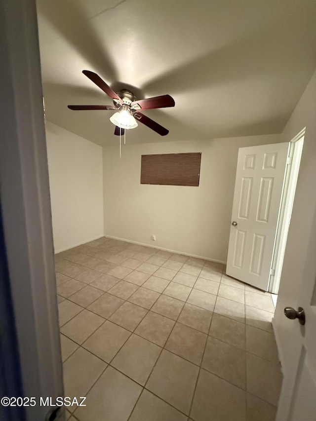 unfurnished room with a ceiling fan and light tile patterned flooring