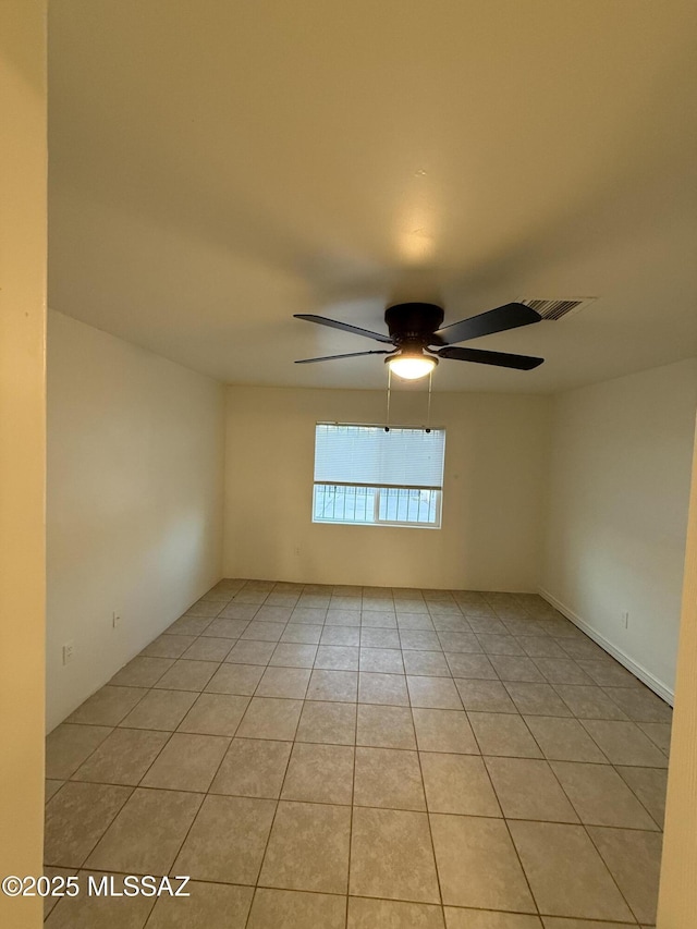 unfurnished room with light tile patterned floors and a ceiling fan