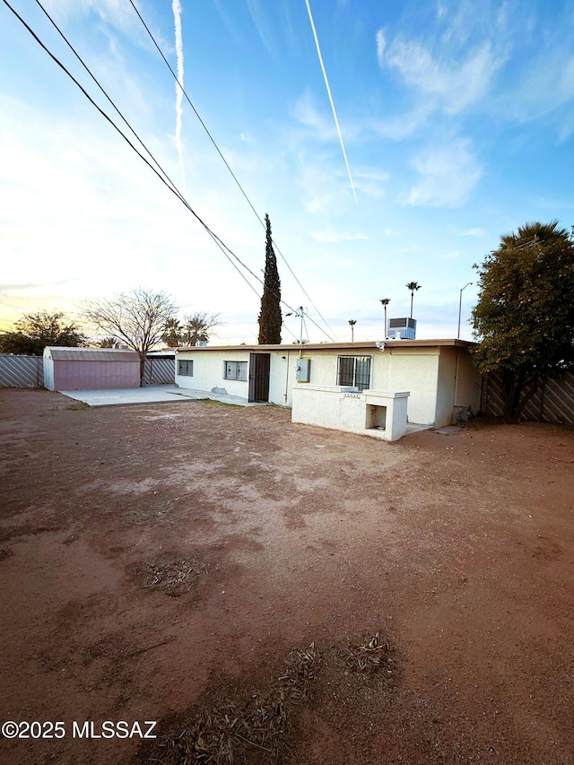 back of property featuring a patio, fence, and stucco siding