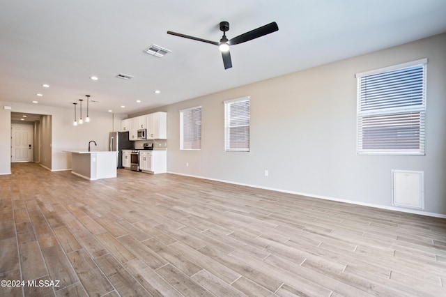 unfurnished living room featuring recessed lighting, light wood-type flooring, visible vents, and a ceiling fan