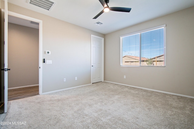 unfurnished bedroom with light carpet, visible vents, and baseboards