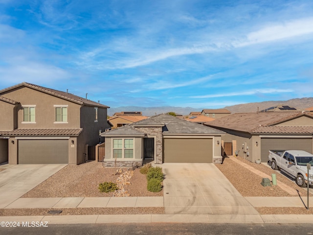 view of front facade with a residential view, concrete driveway, and stucco siding