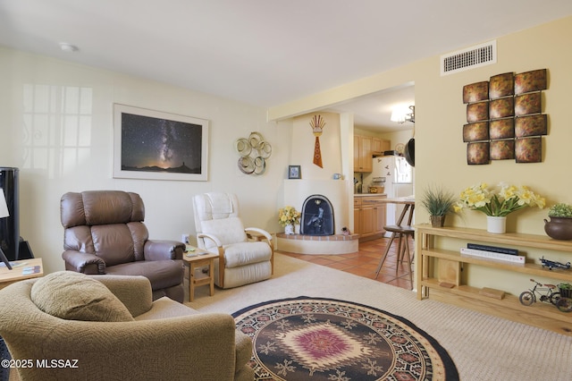 living area featuring light tile patterned flooring and visible vents