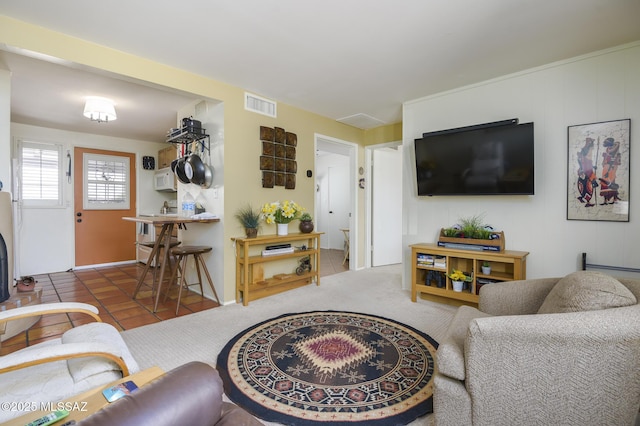 carpeted living room featuring tile patterned floors and visible vents