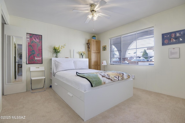 bedroom with a ceiling fan and light carpet