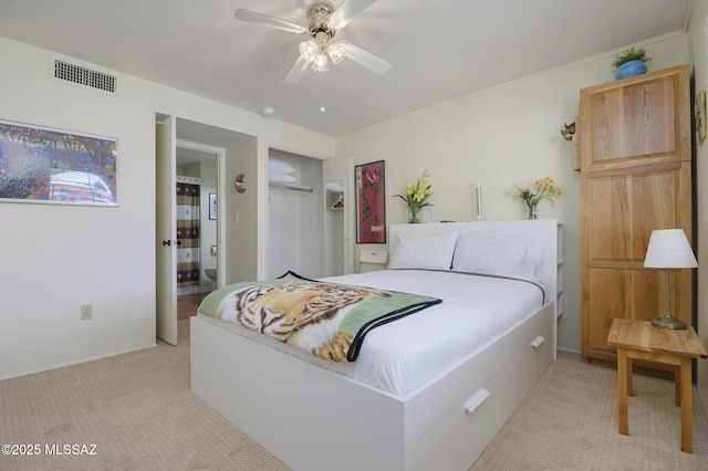 bedroom featuring a ceiling fan, visible vents, a closet, light carpet, and connected bathroom