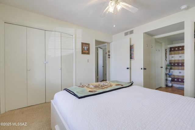 bedroom with visible vents, a closet, and ceiling fan