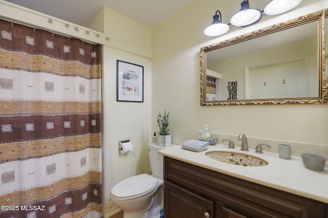 bathroom featuring curtained shower, toilet, and vanity