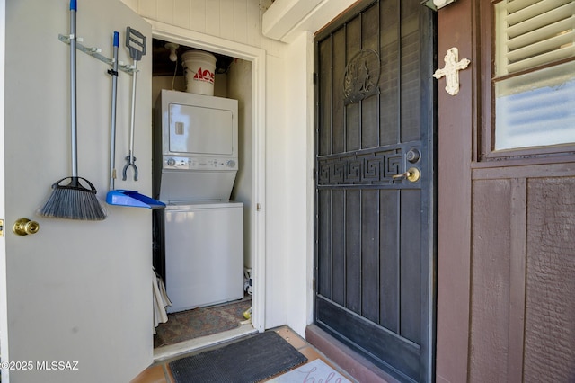 view of exterior entry with stacked washer and dryer